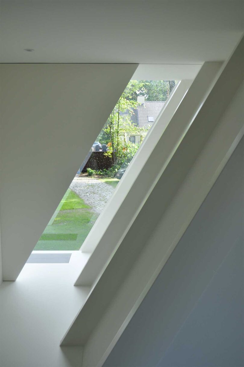 interior shot showing white window shade closing on a-frame house