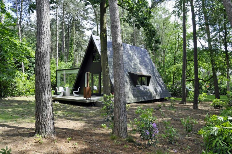 angled exterior view of modern a-frame house in woods