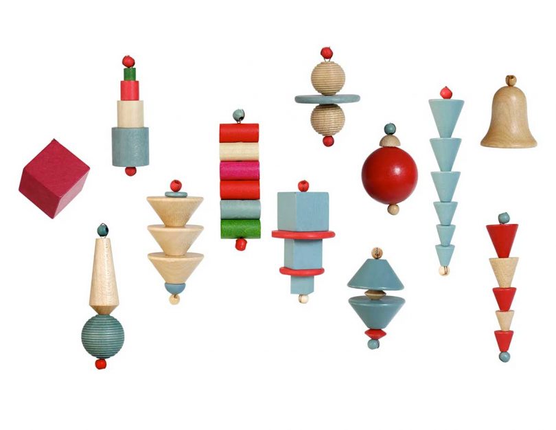 series of hanging bauhaus-inspired christmas ornaments in wood, blue, and reds
