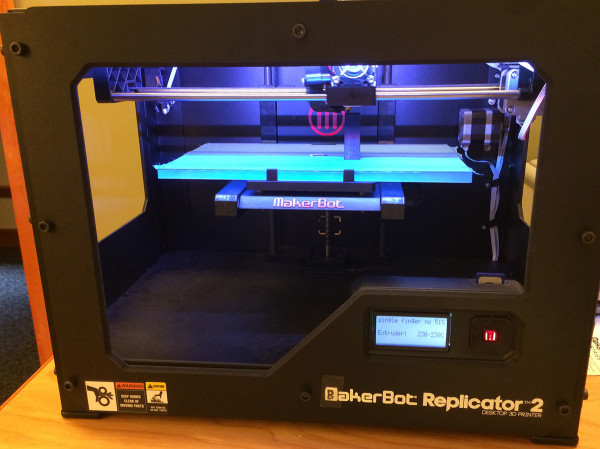 An overall view of the Makerbot Replicator 2 printing one of the “fingers” for the perforated textile block molds.