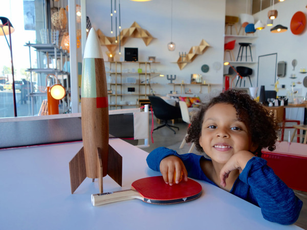 Nina is inside the La Brea flagship, sharing the spotlight with solid walnut Rocket by Pat Kim at the You+Me Ping Pong+Conference/Dining Table by RS Barcelona.