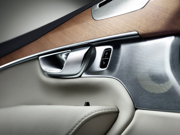 The XC90's interior cabin is a harmonious confluence of warm wood veneer, the cool touch of metal, and premium leather (seat firmness adjustable by the touch of a button).  Leather stitching, surrounding wood grain, and the perforations dotted across the speaker grill all invite a directional flow both visually and with the tactile experience in mind. 