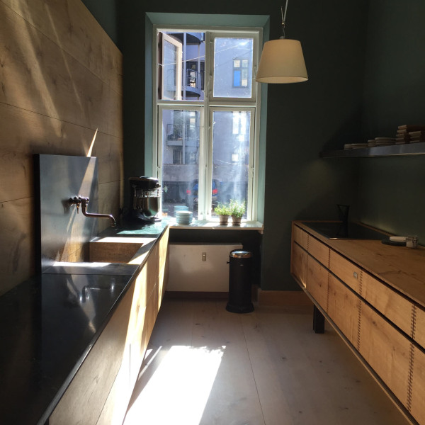 Dinesen's kitchen has wood floors and wooden cabinets