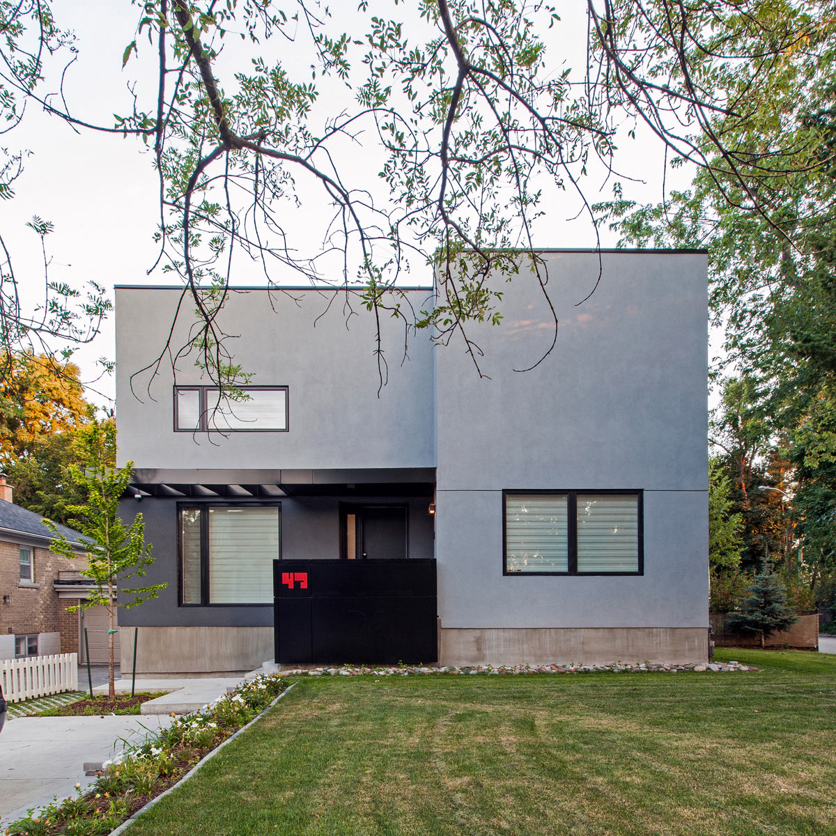 A Bungalow is Replaced with a Minimalist, Two-Story House