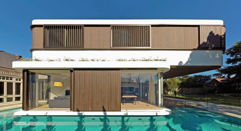 A Modern House with a Wraparound Swimming Pool
