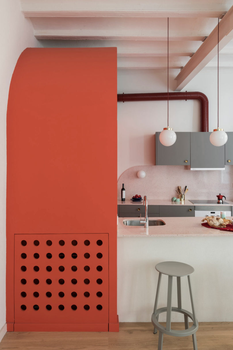 partial view of modern kitchen with grey cabinets and orange structure