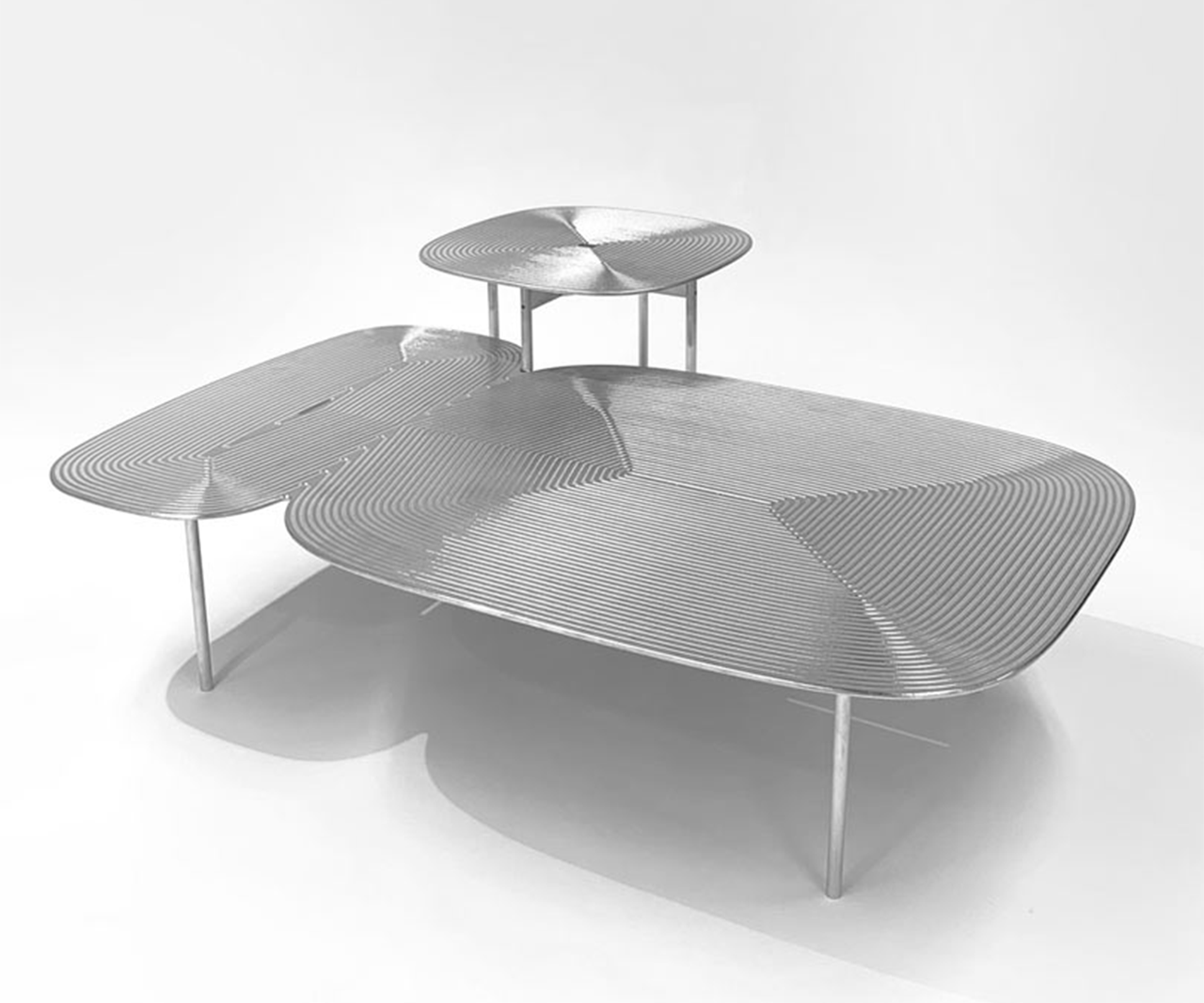 The Collate Table Collection Uses Aluminum as a Playful Canvas