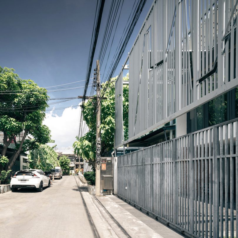 Two Bangkok Townhouses Become One With a Cage-Like Fence for Privacy