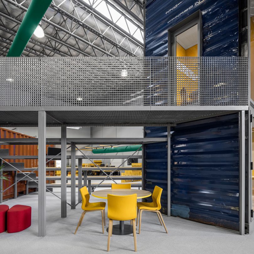 A Warehouse Is Transformed With Shipping Containers Into