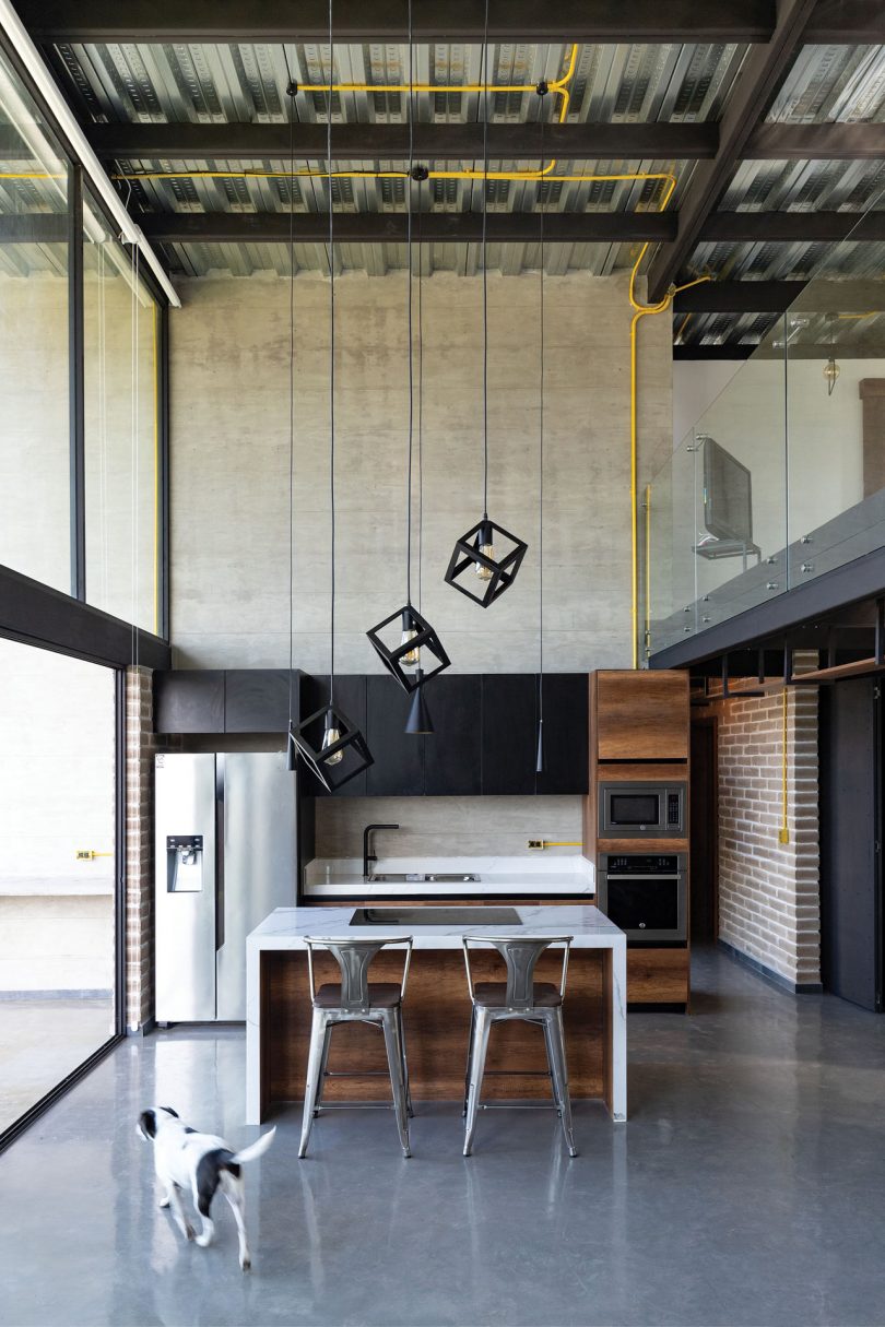interior view of industrial modern house with double height ceiling in kitchen