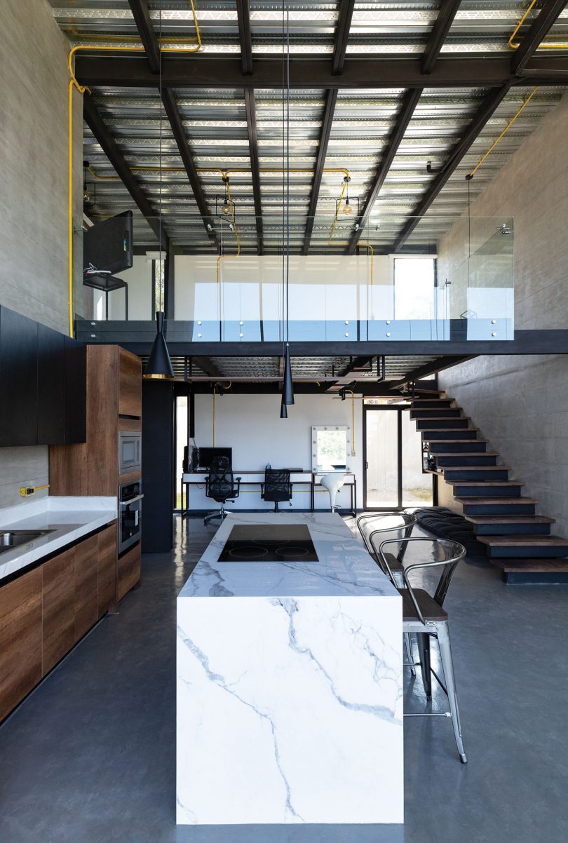 interior view of industrial modern house with double height ceiling and mezzanine level