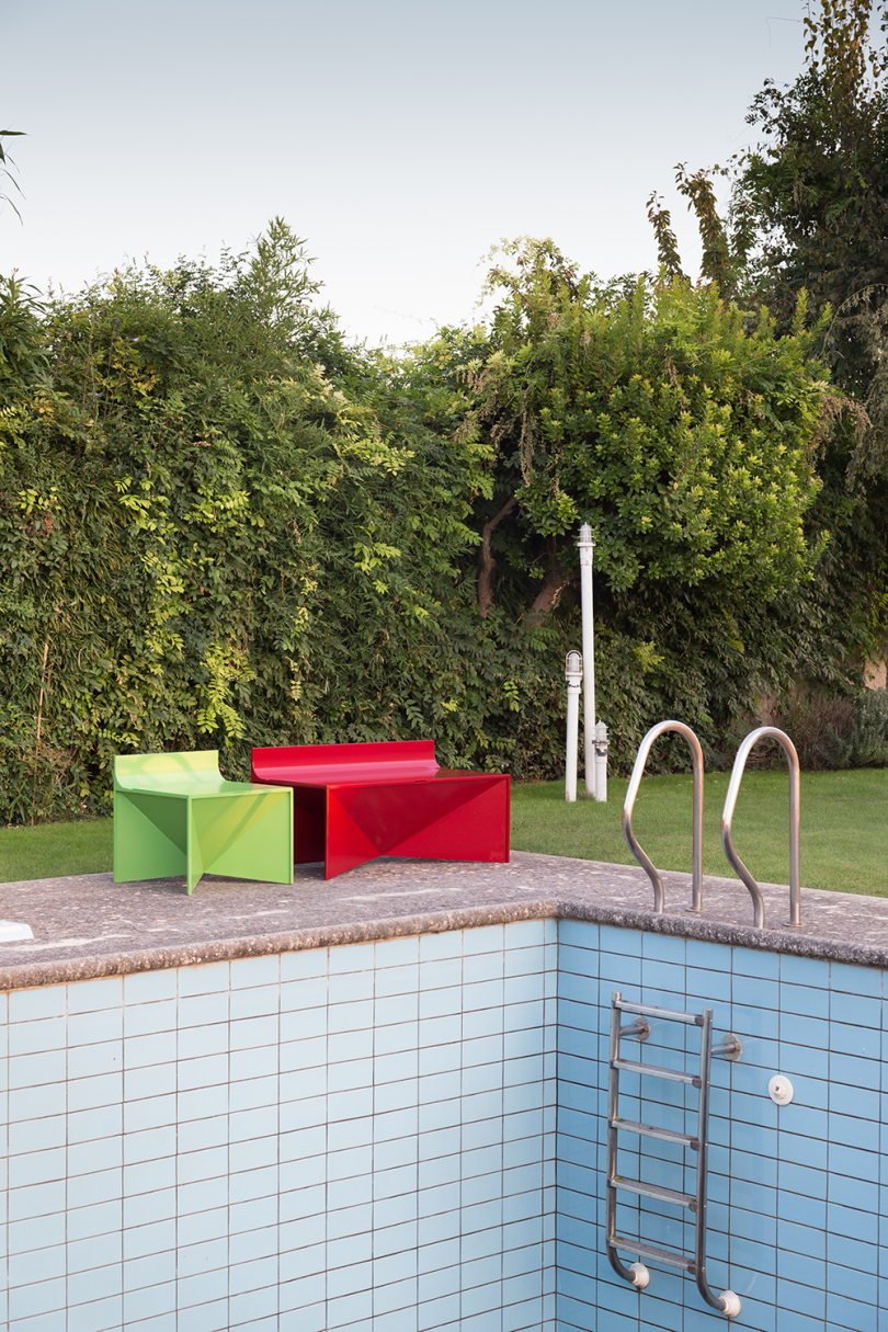 metal outdoor chair and bench by pool