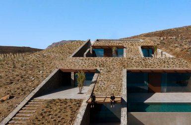 A Cave-Like Home Built into a Rocky Cove Overlooking the Aegean Sea