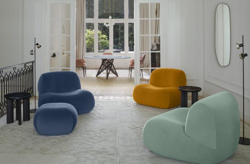 living space with three chairs and pouf