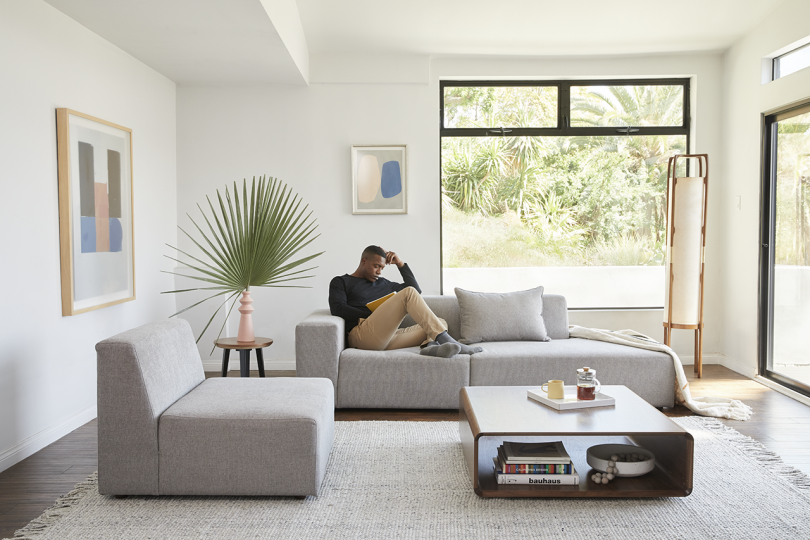 sectional sofa in living space with man