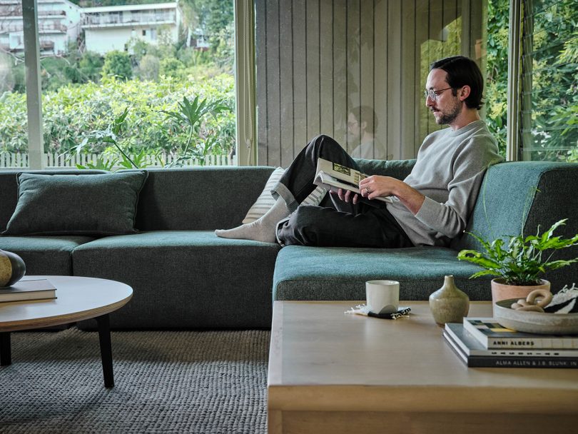 sectional sofa in living space with man