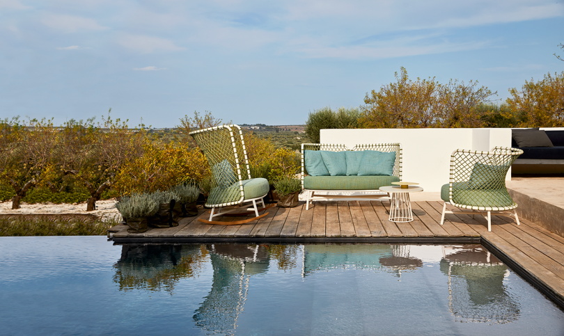 outdoor furniture next to pool