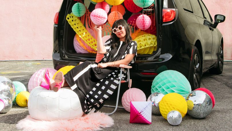 Joy Cho sitting in front of decorated mini van