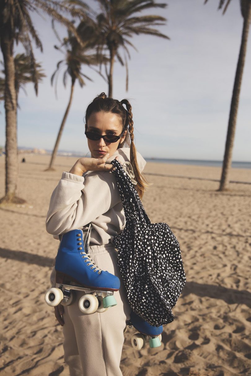 girl at the beach carrying a tote