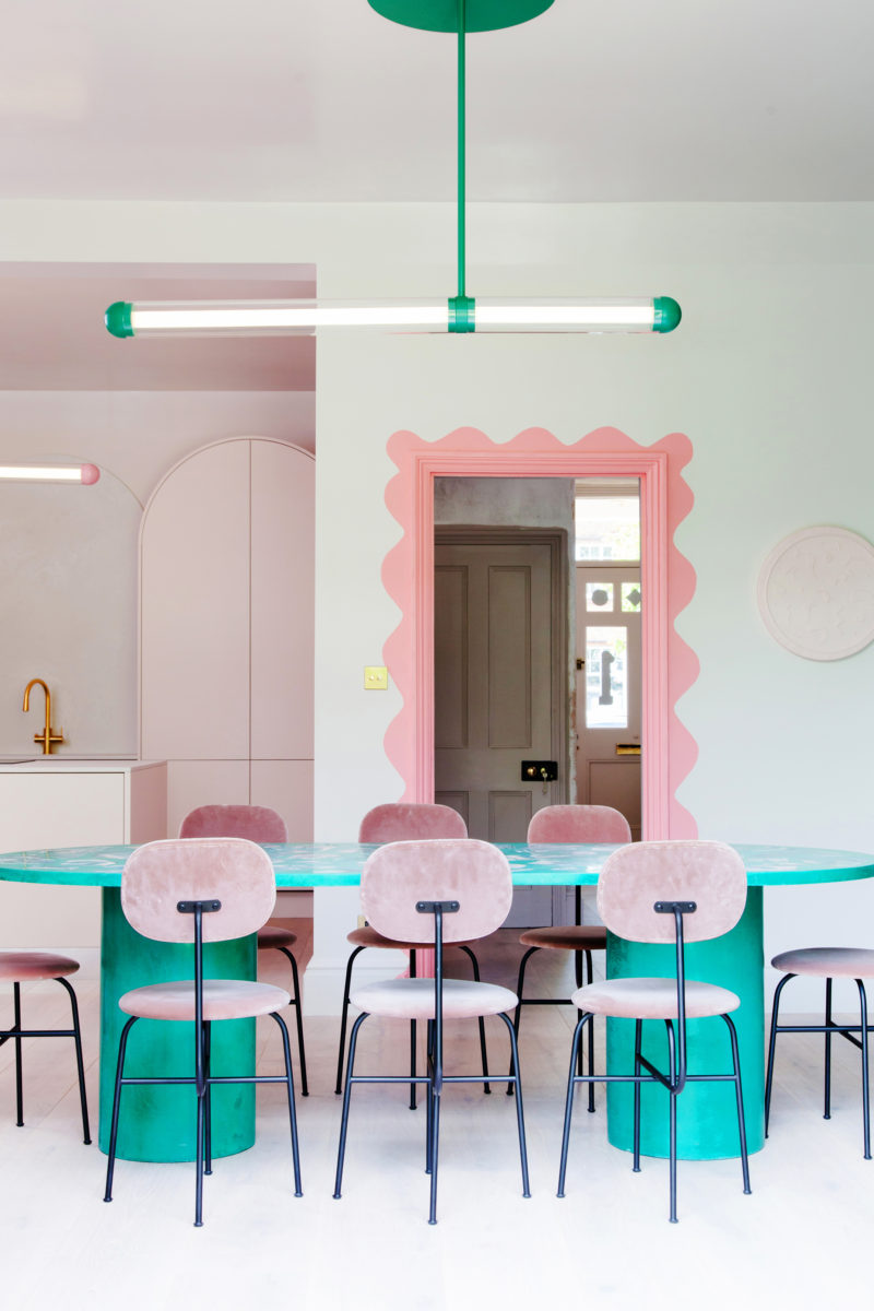 dining room with green table and pink chairs
