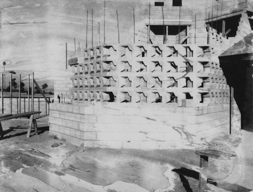 black and white photo of house being built with textile blocks