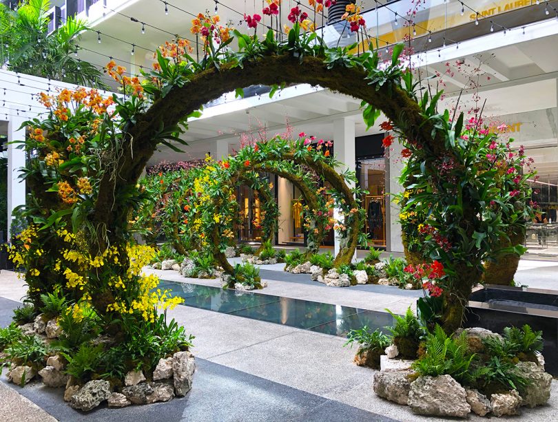 interior installation of arches of greenery and flowers