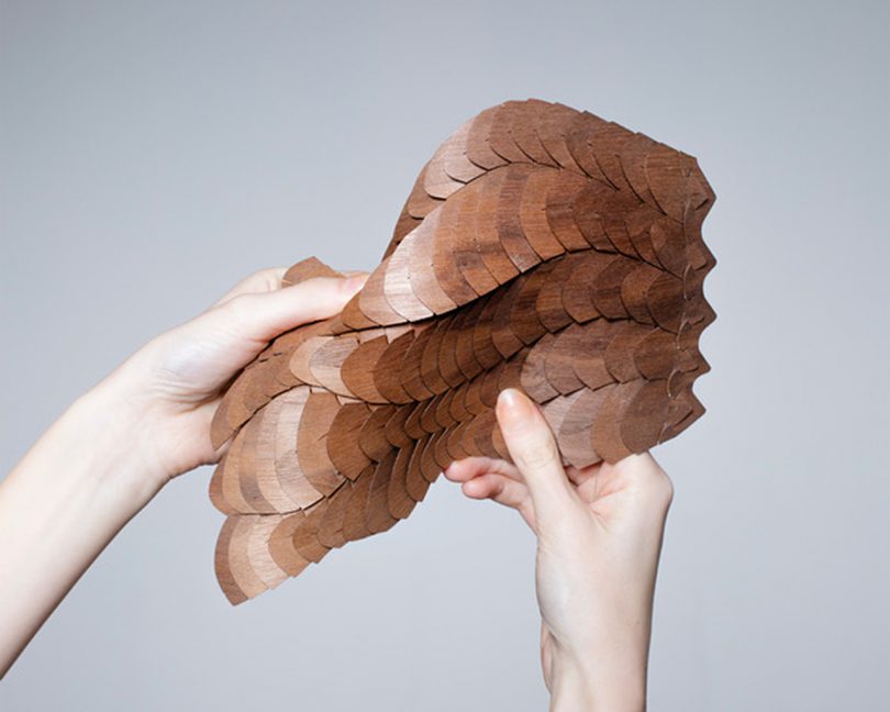 brown modular material being manipulated by two hands
