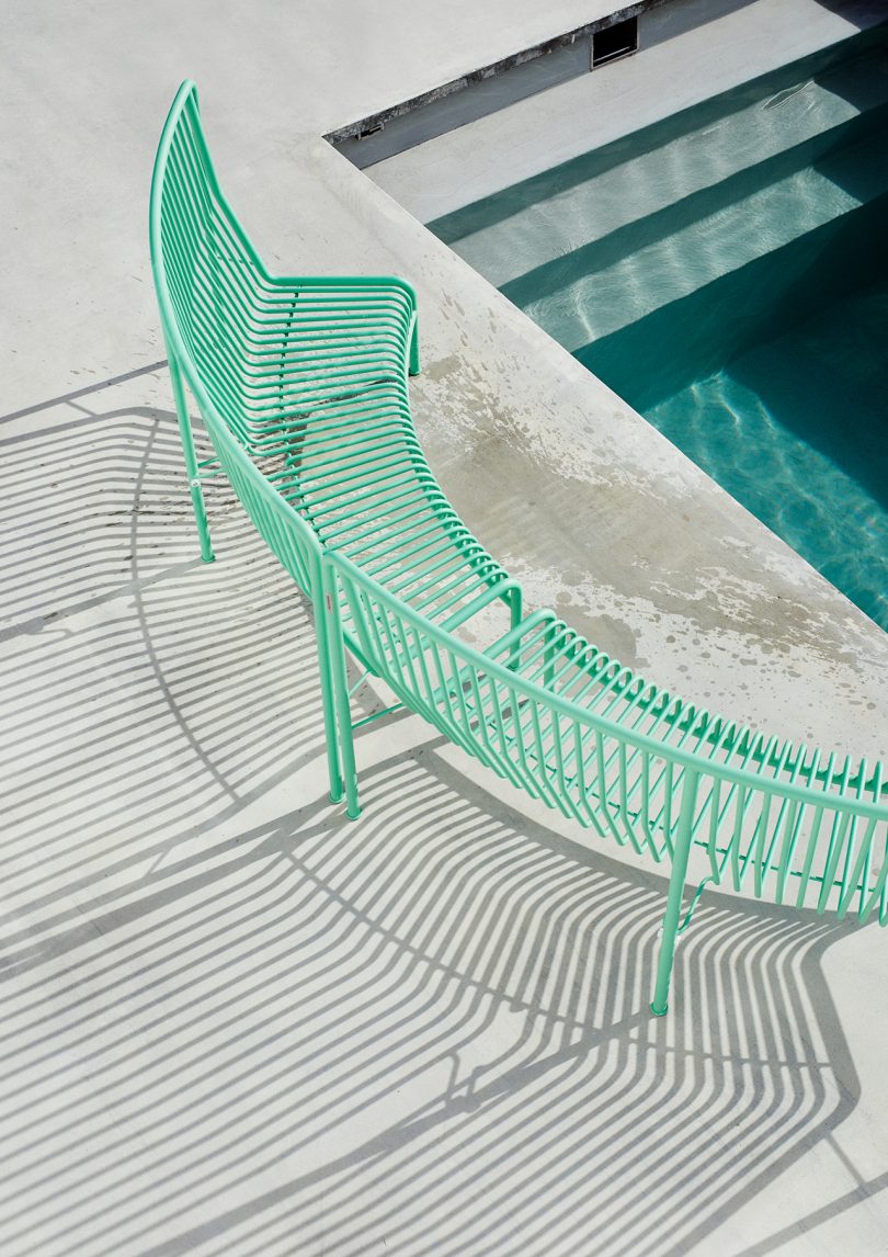 green wire bench poolside