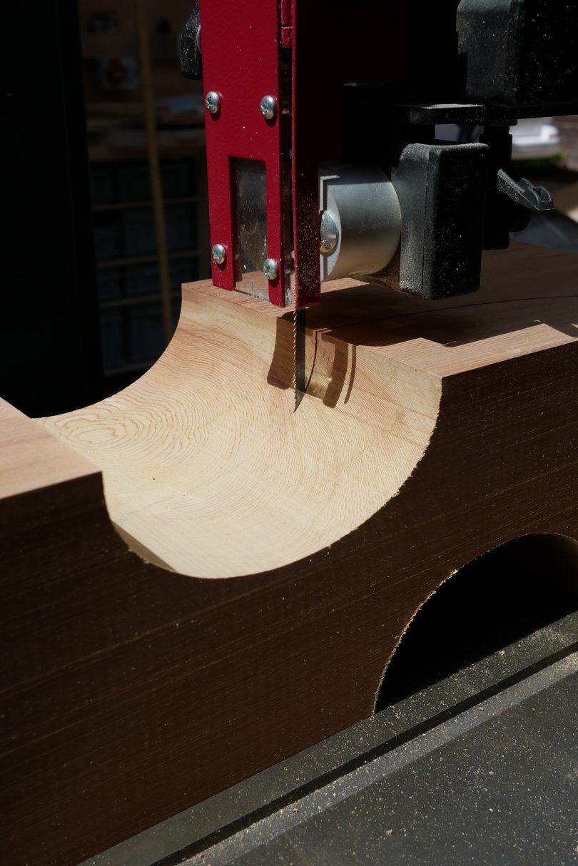 asymmetrical red cedar chair design being cut