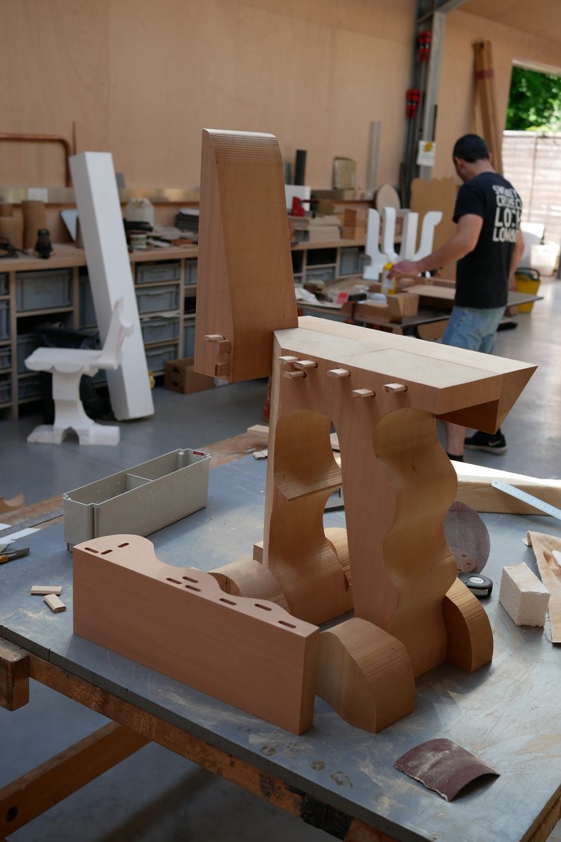 asymmetrical red cedar chair being put together in workshop