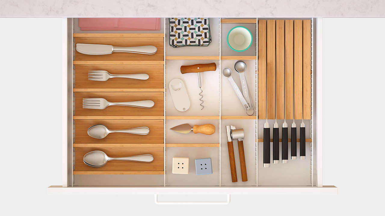 overhead photo of adjustable drawer organizer with kitchen utensils