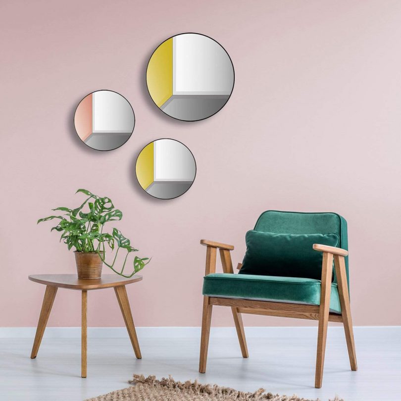 three multicolor round wall mirrors in living space