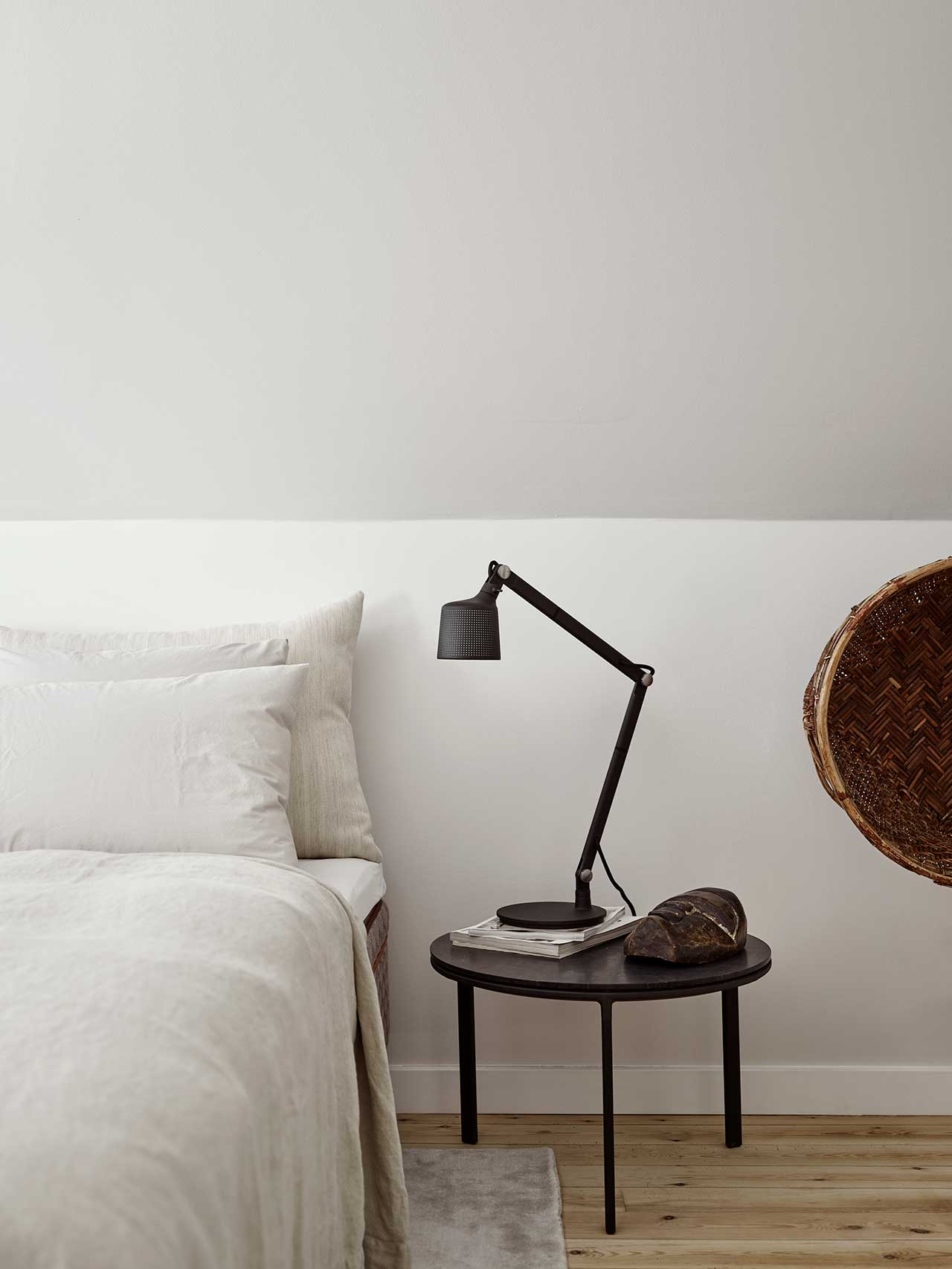 edge of bed with side table and lamp