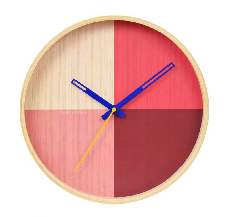 wooden wall clock with face in pink hues