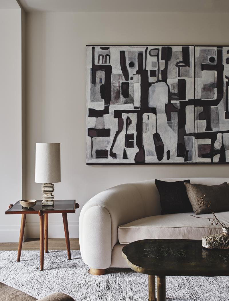 living space with sofa, side table, coffee table, and black and white art