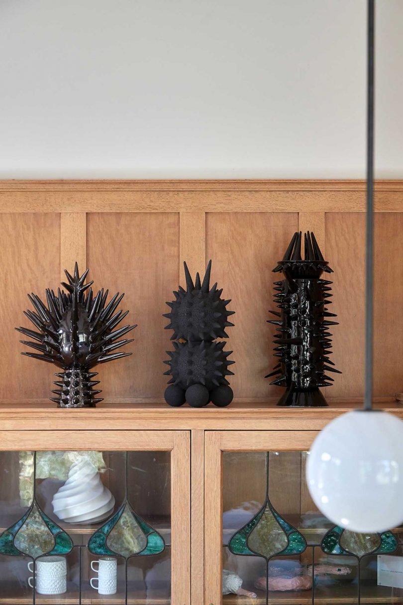 modern black sculptures on shelf