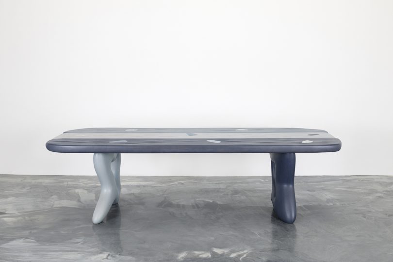 abstract table on concrete floor in front of white wall