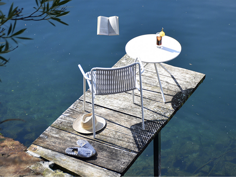 white armchair and bistro table on dock