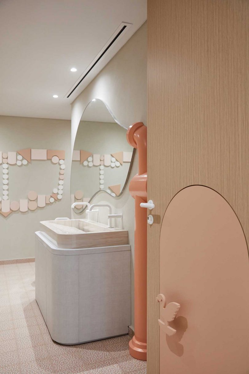 modern office bathroom with pink details
