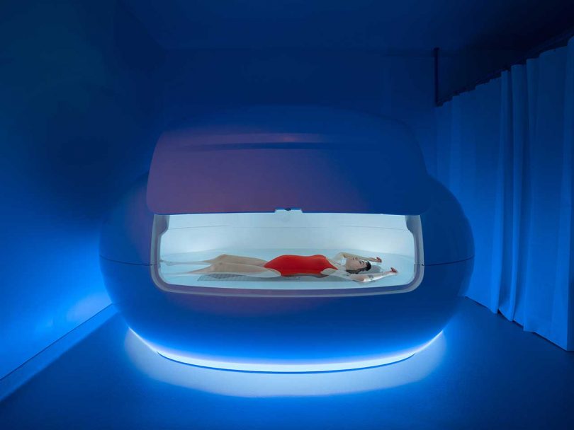 dark room with person floating in floating tank