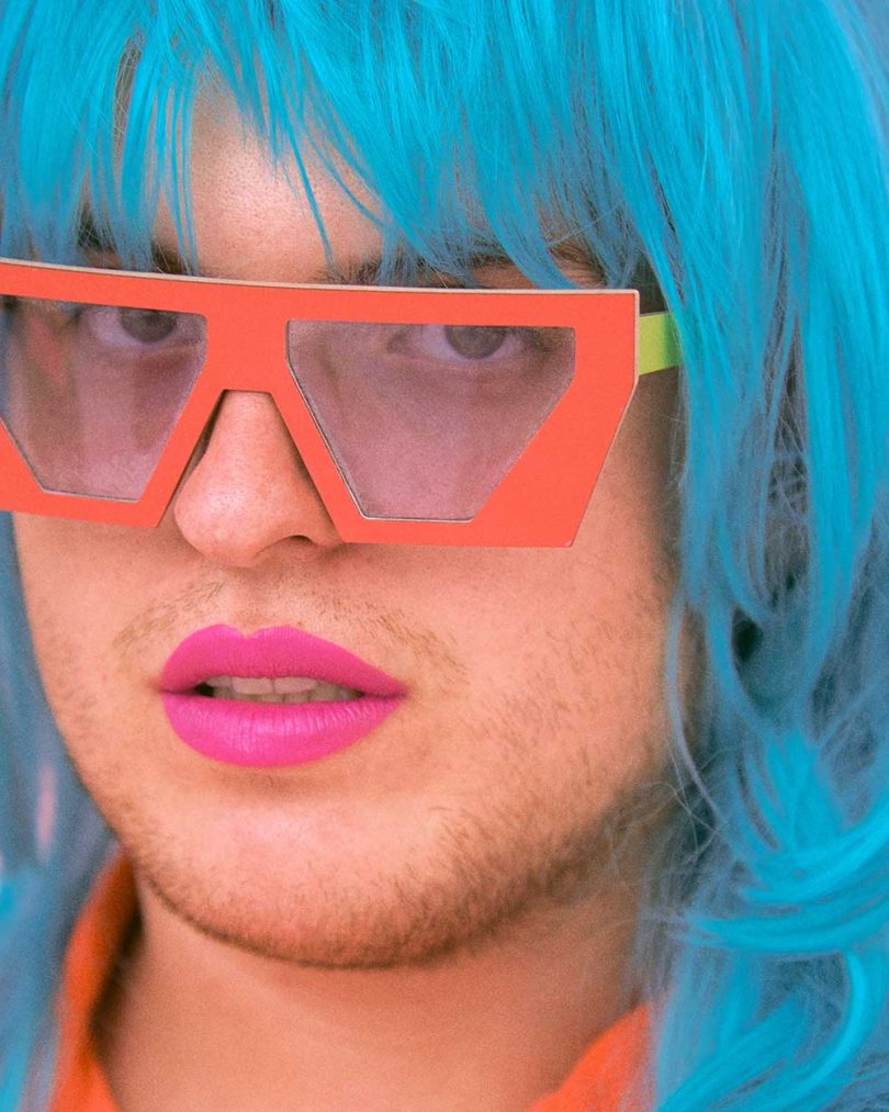 person wearing blue wig and orange sunglasses