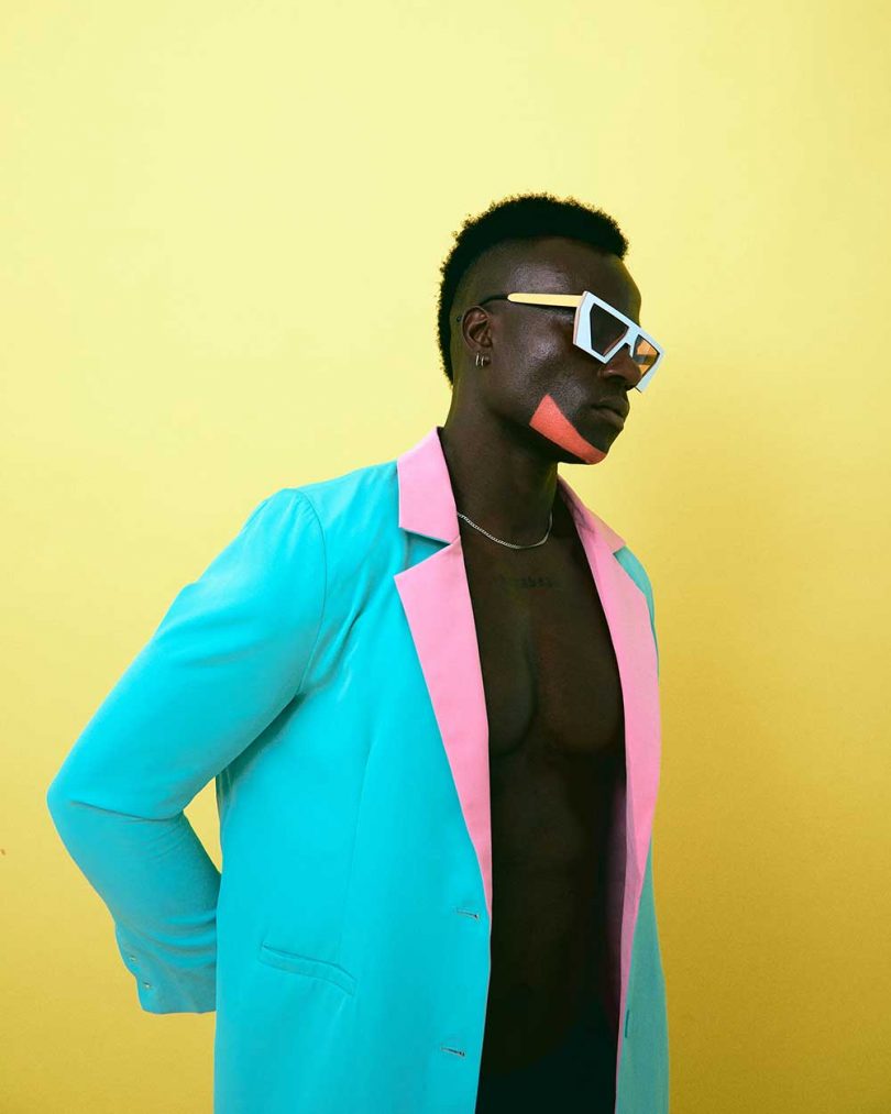 man in neon jacket with colorful sunglasses
