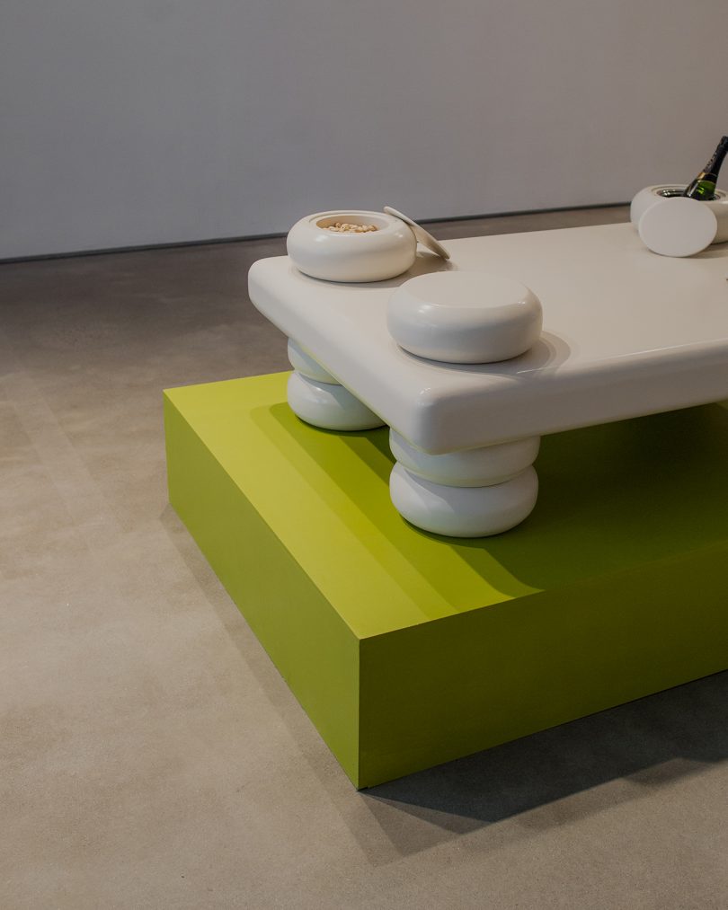 white table on lime green pedestal