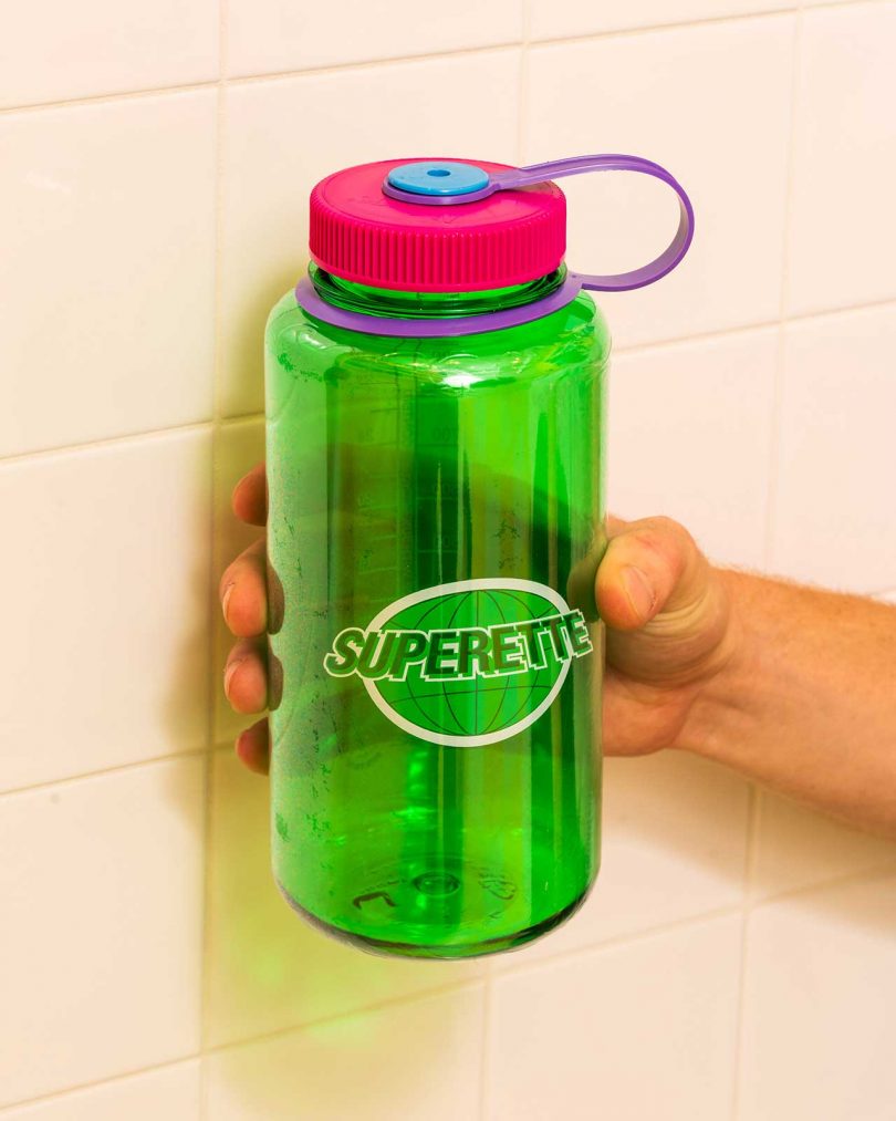 green and pink reusable water bottle with Superette logo