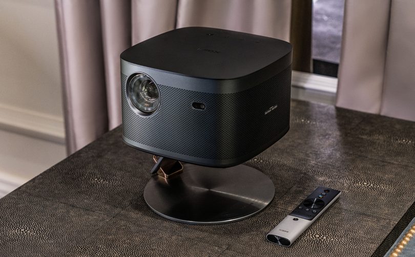 Projector on small stand with remote