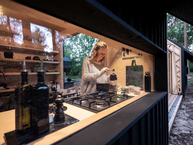 view into cabin of girl making tea