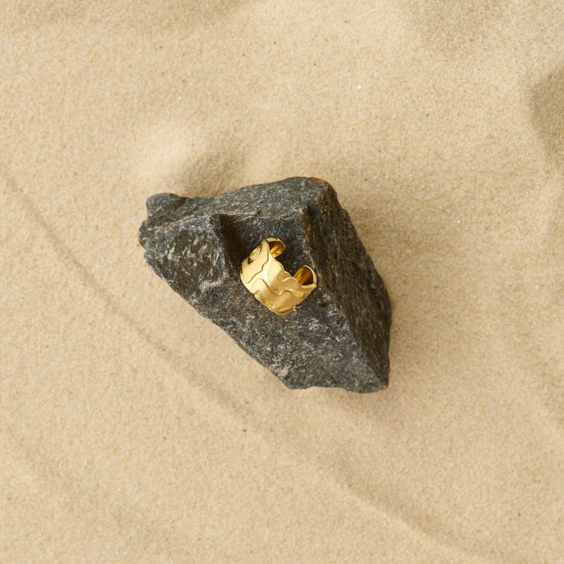 modern gold ring on rock