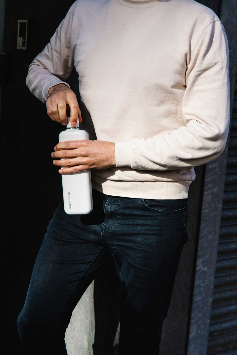 man holding white water bottle