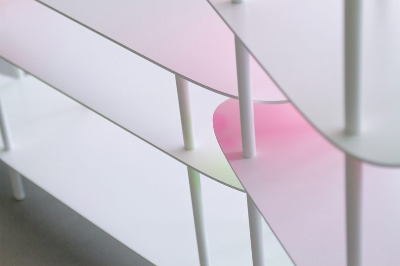 close up of white shelves with a light pink gradient