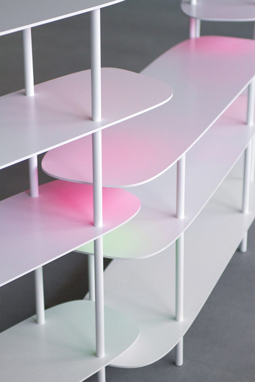 close up of white shelves with a light pink and yellow gradient